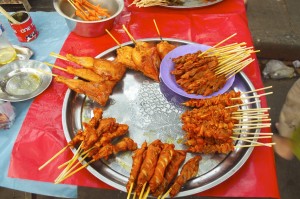 Tasty street food. Hens' feet can be seen in the pot top left.