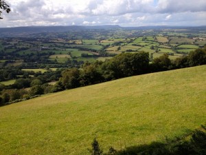 The patchwork of fields with the Black Mountains in the distance